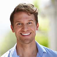 Woman With Hands on Top of One Another While Smiling